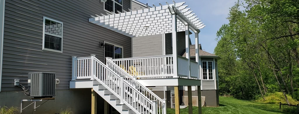 deck with pergola top attached to house with tan siding